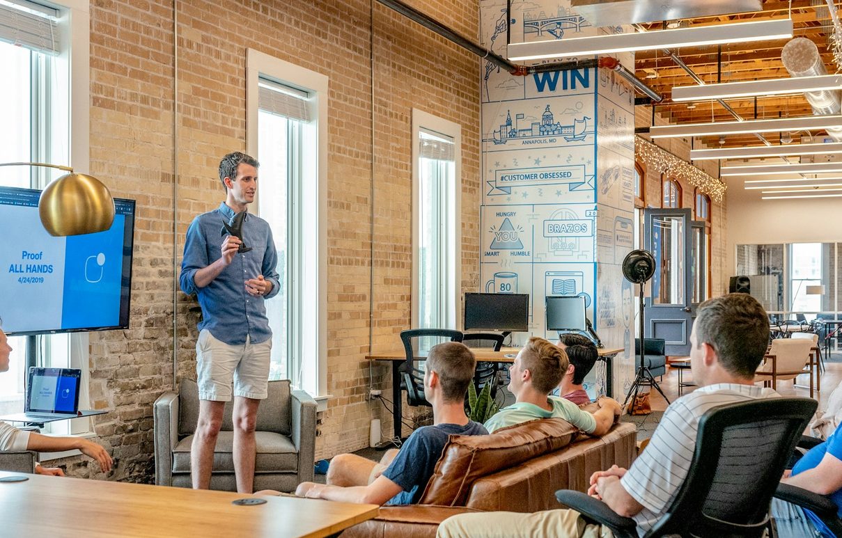 A founder presenting to a small team in an office