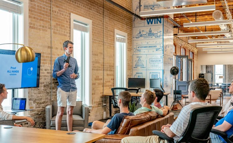 A founder presenting to a small team in an office