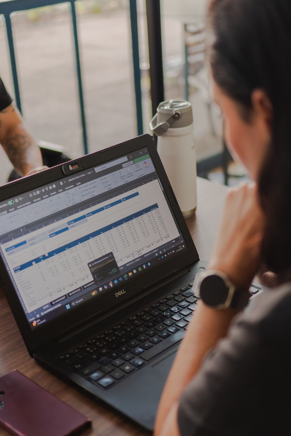 Person analyzing data on laptop screen