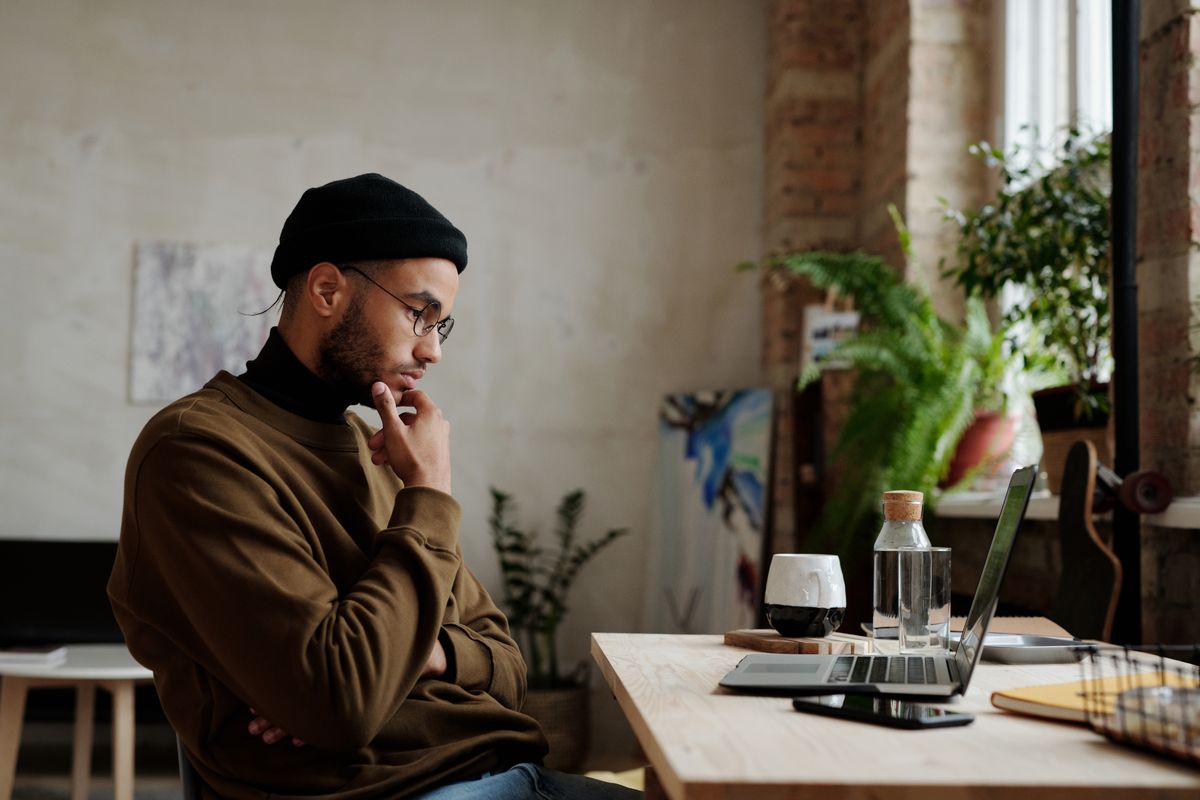 Man thinking while looking at the screen of a laptop