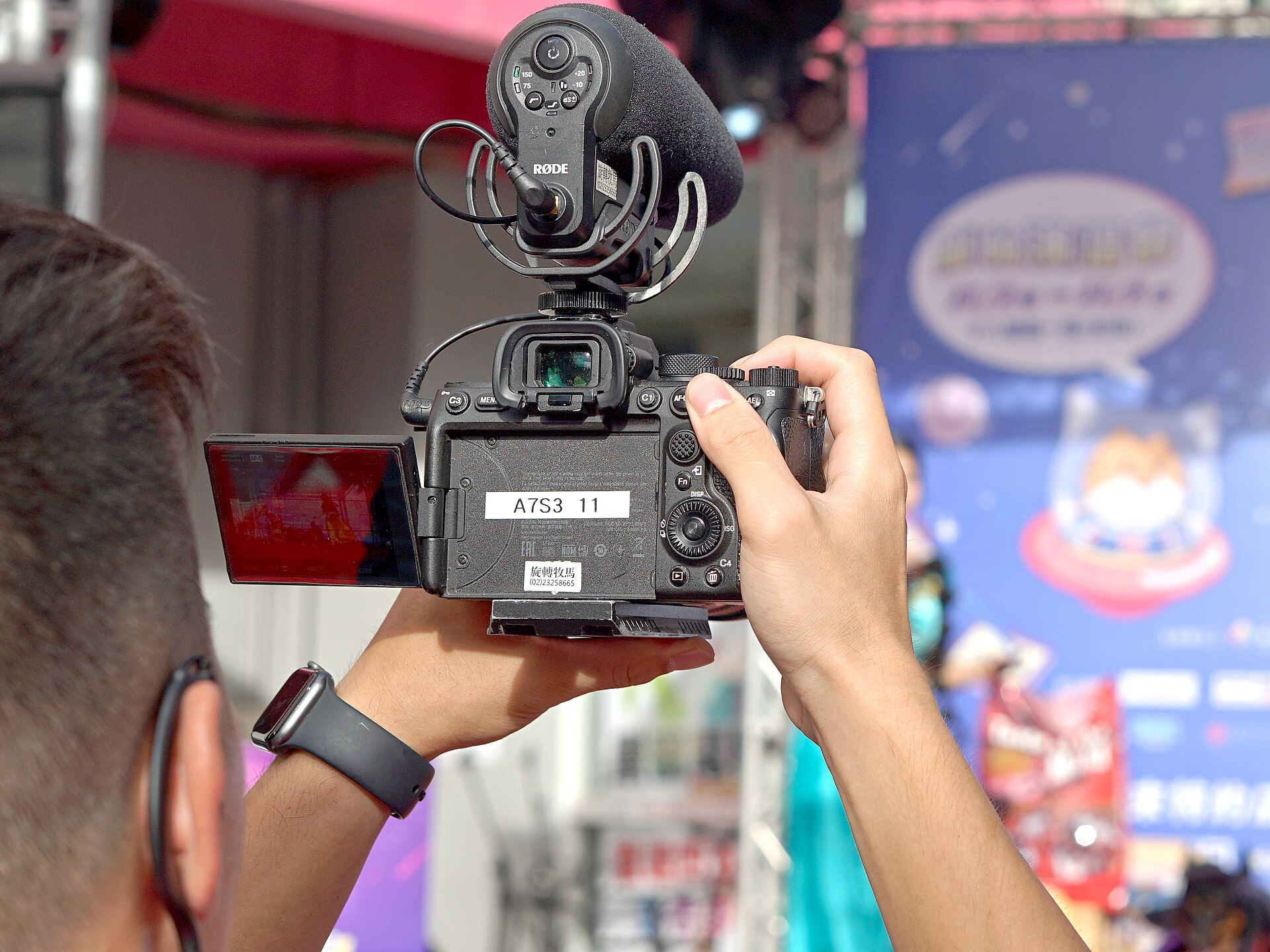 HTIMC male staff recording video with Sony ILCE-7SM3 at stage area 20241019