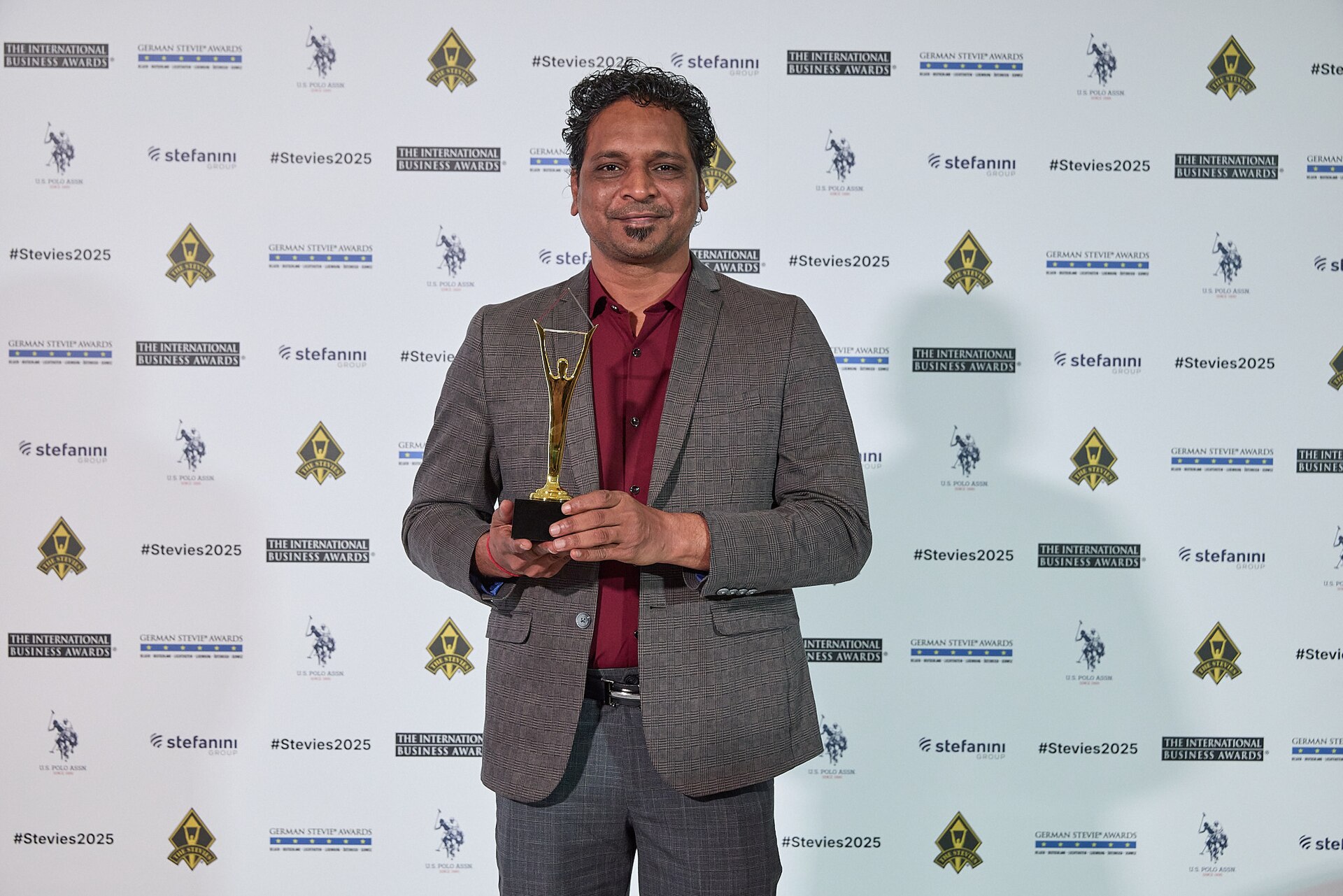Chirag Patel holding Stevie Award trophy, landscape format, 2025