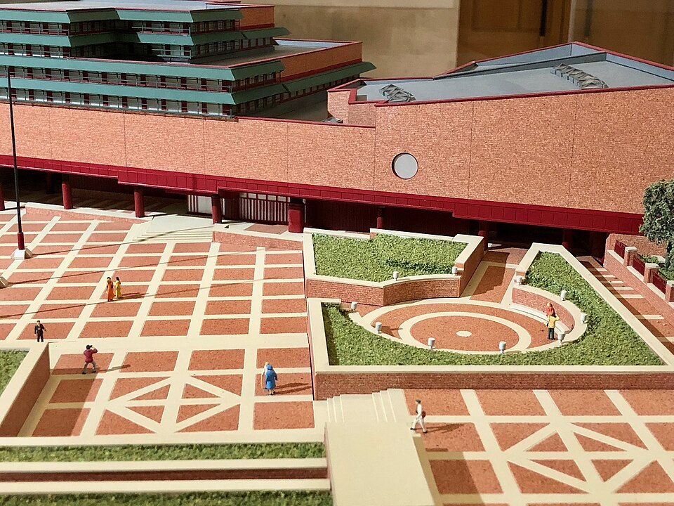 A detailed architectural model of a building and courtyard