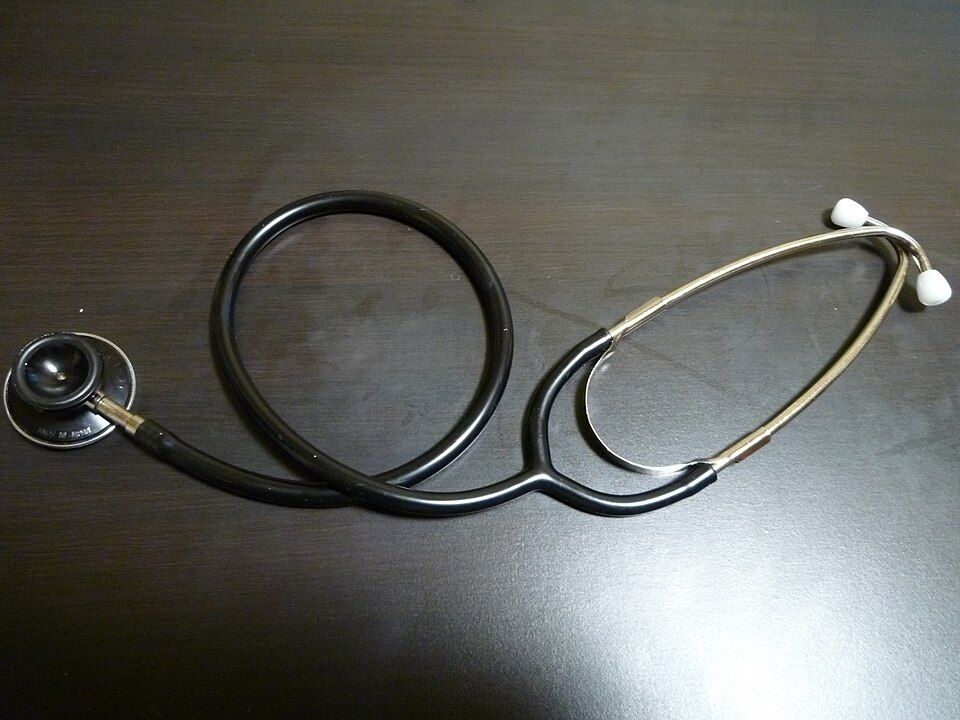 A stethoscope on a dark table