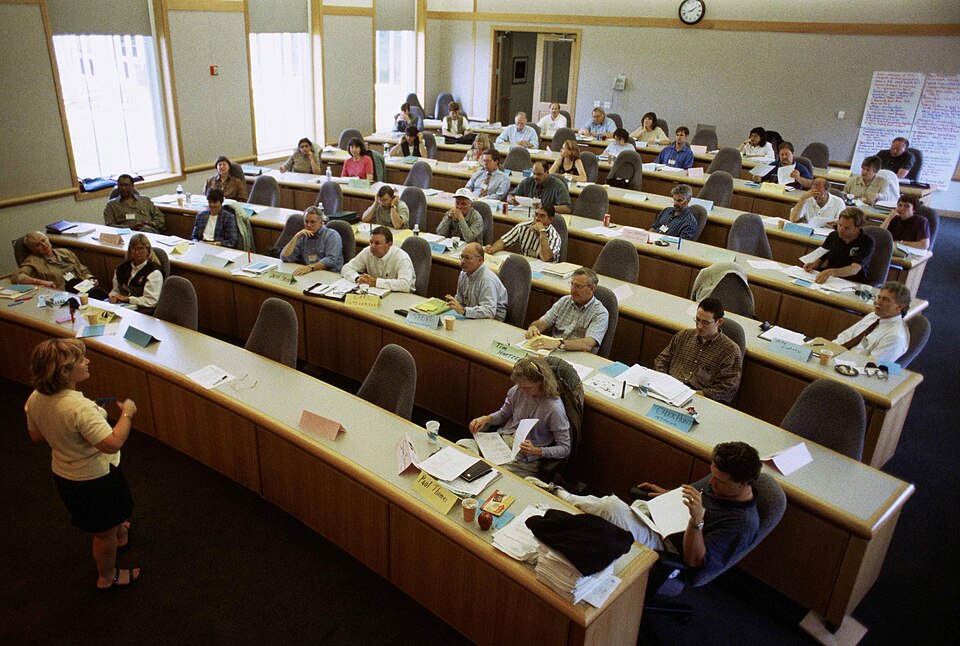 A teacher addressing a full classroom