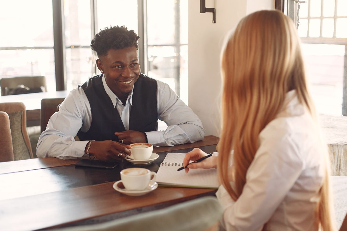 Two people having coffee while talking