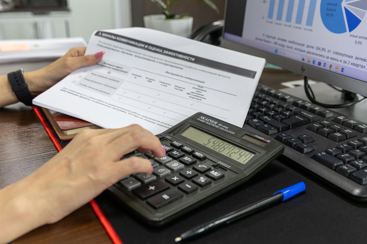 Business calculation with financial document on desk